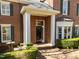 Classic brick home featuring an elegant front entrance with white columns and a dark door at 2820 Glenwood Gardens Ln # 101, Raleigh, NC 27608