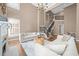 Grand living area with soaring ceilings, fireplace, and staircase with iron railings at 2820 Glenwood Gardens Ln # 101, Raleigh, NC 27608