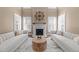 Elegant living room with fireplace, neutral tones, plantation shutters, and an eye-catching centerpiece at 2820 Glenwood Gardens Ln # 101, Raleigh, NC 27608