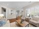 Inviting living room with hardwood floors and large windows offering plenty of natural light at 2820 Glenwood Gardens Ln # 101, Raleigh, NC 27608