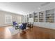 Bright living room featuring hardwood floors, built-in shelving, and cozy seating at 2820 Glenwood Gardens Ln # 101, Raleigh, NC 27608