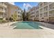 A luxurious in-ground outdoor pool surrounded by upscale condo buildings and lush landscaping at 2820 Glenwood Gardens Ln # 101, Raleigh, NC 27608