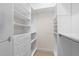 Well-organized walk-in closet with custom shelving and drawers for ample storage at 2820 Glenwood Gardens Ln # 101, Raleigh, NC 27608