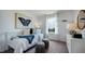 Bright bedroom showcasing a butterfly painting, white furniture, and a view to the outside at 284 Hank Way, Angier, NC 27501