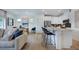Open-concept living and dining area adjacent to a kitchen with a large island and modern appliances at 284 Hank Way, Angier, NC 27501
