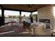 Relaxing outdoor patio with stone fireplace, ceiling fan, and outdoor furniture at 3012 Dog Rose Dr # 305, Durham, NC 27703