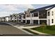 Modern townhomes line the street, each with its own garage and stylish exterior design at 3012 Dog Rose Dr # 305, Durham, NC 27703