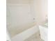 A clean bathtub and modern vanity with a granite countertop enhances the bathroom's appeal at 303 E C St, Butner, NC 27509
