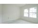 This bedroom features two large windows, flooding the room with natural light at 303 E C St, Butner, NC 27509