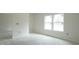 A bedroom illuminated by two windows, complemented by light-colored walls and flooring at 303 E C St, Butner, NC 27509