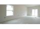 Spacious living room with a sliding glass door and a large window at 303 E C St, Butner, NC 27509