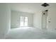 Open-concept living room with a sliding glass door and a view of the backyard at 303 E C St, Butner, NC 27509