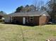 Rear exterior view with brick facade, white doors, and well maintained landscaping at 3132 Fields Dr, Raleigh, NC 27603