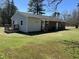 Exterior shot revealing back porch and rear view of the gray and brick house with a well kept lawn at 3132 Fields Dr, Raleigh, NC 27603