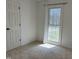 Bedroom with white walls, carpet, and a bright window showcasing the view outside at 3132 Fields Dr, Raleigh, NC 27603