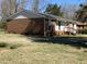 Side exterior showcasing brick facade, manicured lawn, and well-maintained landscaping at 3132 Fields Dr, Raleigh, NC 27603