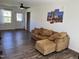 Bright living room with hard wood floors, a comfortable sofa and a ceiling fan at 3132 Fields Dr, Raleigh, NC 27603