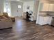 Open living room with wood floors, neutral tones, and a view into the kitchen at 3132 Fields Dr, Raleigh, NC 27603