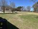 View of the lawn in a yard with nearby buildings and trees in the background at 3132 Fields Dr, Raleigh, NC 27603