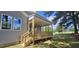 A cozy covered porch with wooden steps and railings, perfect for enjoying the outdoors at 33 White Azalea Way, Homesite 80, Benson, NC 27504
