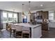 A modern kitchen island featuring pendant lighting, barstool seating, and stainless appliances at 33 White Azalea Way, Homesite 80, Benson, NC 27504