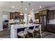 Contemporary kitchen featuring an island with barstool seating, stainless steel appliances, and granite counters at 33 White Azalea Way, Homesite 80, Benson, NC 27504