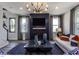 Inviting living room featuring a modern chandelier, dark accent wall, and plush seating at 33 White Azalea Way, Homesite 80, Benson, NC 27504
