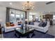 Open-concept living room with large windows, comfortable seating, and sight lines to the kitchen at 33 White Azalea Way, Homesite 80, Benson, NC 27504