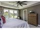 Comfortable main bedroom featuring a bed, dresser, and large windows with natural light at 33 White Azalea Way, Homesite 80, Benson, NC 27504