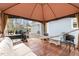 A covered backyard deck features a comfortable seating area and a hammock at 3650 Durwood Ln, Raleigh, NC 27604