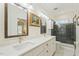 Bright bathroom with double vanity, marble counters, and a walk-in shower at 3650 Durwood Ln, Raleigh, NC 27604