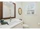Bright bathroom with quartz countertops, framed mirror and a glass-enclosed shower at 3650 Durwood Ln, Raleigh, NC 27604