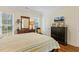 Comfortable bedroom with wooden floors, natural light and a dresser at 3650 Durwood Ln, Raleigh, NC 27604
