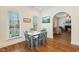 Bright dining area with wood floors, natural light, and an archway to the living room at 3650 Durwood Ln, Raleigh, NC 27604