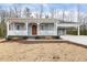 Beautiful light blue home featuring a covered porch and convenient side carport at 3650 Durwood Ln, Raleigh, NC 27604