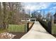 Gated home with a long driveway and exterior gate at 3650 Durwood Ln, Raleigh, NC 27604