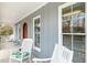 Relaxing front porch with rocking chairs and light blue wood siding at 3650 Durwood Ln, Raleigh, NC 27604