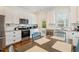 Bright kitchen with stainless appliances, granite counters, and white cabinets at 3650 Durwood Ln, Raleigh, NC 27604