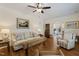 Cozy living room with hardwood floors, a ceiling fan, and lots of natural light at 3650 Durwood Ln, Raleigh, NC 27604