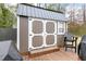The outdoor shed has barn doors, a window, and a wooden deck with a chair at 3650 Durwood Ln, Raleigh, NC 27604