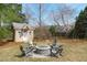 Landscaped backyard featuring shed, fire pit, and seating area, ideal for outdoor gatherings and relaxation at 3708 Wesley Ridge Dr, Apex, NC 27539