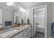 Bathroom features a double vanity with granite countertops, modern fixtures, and a separate tub area at 3708 Wesley Ridge Dr, Apex, NC 27539
