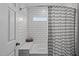 Bathroom featuring a tub with a shower, stylish tiling, and a window for natural light at 3708 Wesley Ridge Dr, Apex, NC 27539