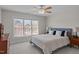 Bright bedroom featuring a large window, ceiling fan, and stylish furnishings creating a cozy retreat at 3708 Wesley Ridge Dr, Apex, NC 27539