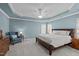 Spacious bedroom features a large bed, sitting area, tray ceiling, and neutral color palette at 3708 Wesley Ridge Dr, Apex, NC 27539