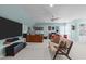 Bonus room with seating, a large tv and desk providing a comfortable and functional entertainment space at 3708 Wesley Ridge Dr, Apex, NC 27539