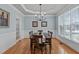 Formal dining room featuring hardwood floors, decorative trim, and ample natural light at 3708 Wesley Ridge Dr, Apex, NC 27539