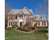 Charming two-story brick home with a manicured front lawn and mature landscaping at 3708 Wesley Ridge Dr, Apex, NC 27539