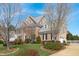 Beautiful two-story home with brick and siding, lush lawn, and mature trees at 3708 Wesley Ridge Dr, Apex, NC 27539