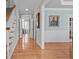 Elegant foyer with hardwood floors, staircase, and wainscoting leading to formal dining and living spaces at 3708 Wesley Ridge Dr, Apex, NC 27539